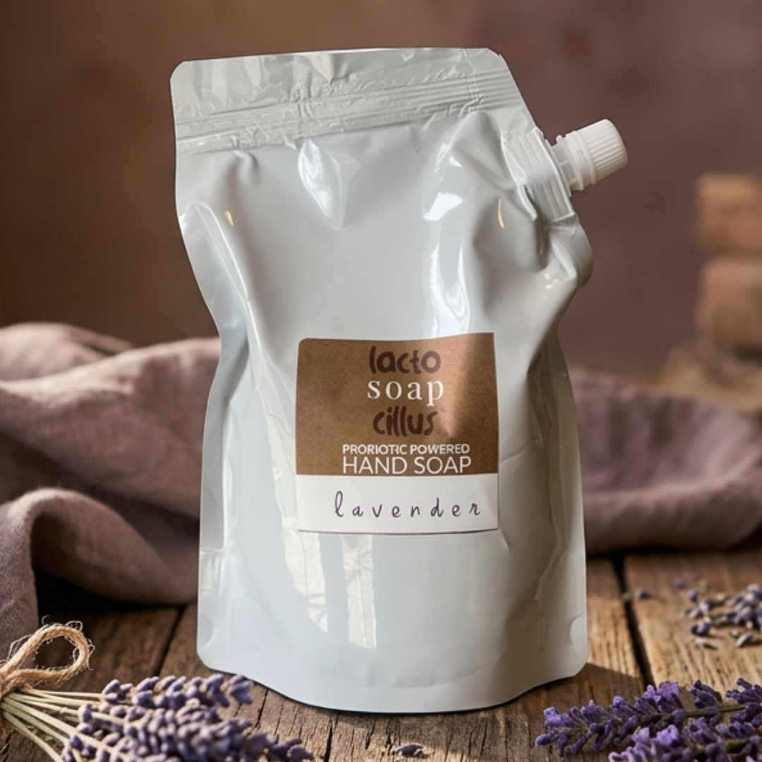 Lacto Soap Cillus lavender hand soap packaging on a wooden surface with lavender flowers.