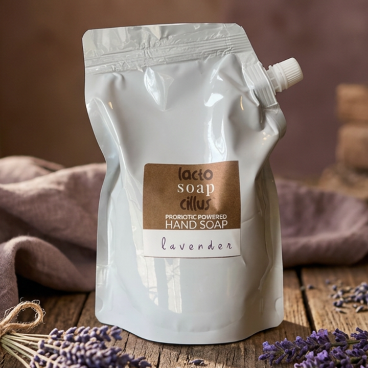 Lacto Soap Cillus lavender hand soap packaging on a wooden surface with lavender flowers.