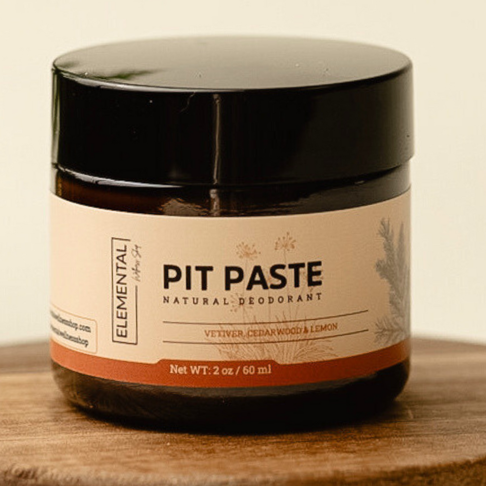 Natural Deodorant Pit Paste by Elemental Wellness in a 2 oz amber glass jar with vetiver, cedarwood, and lemon scent, ideal for personal care use.