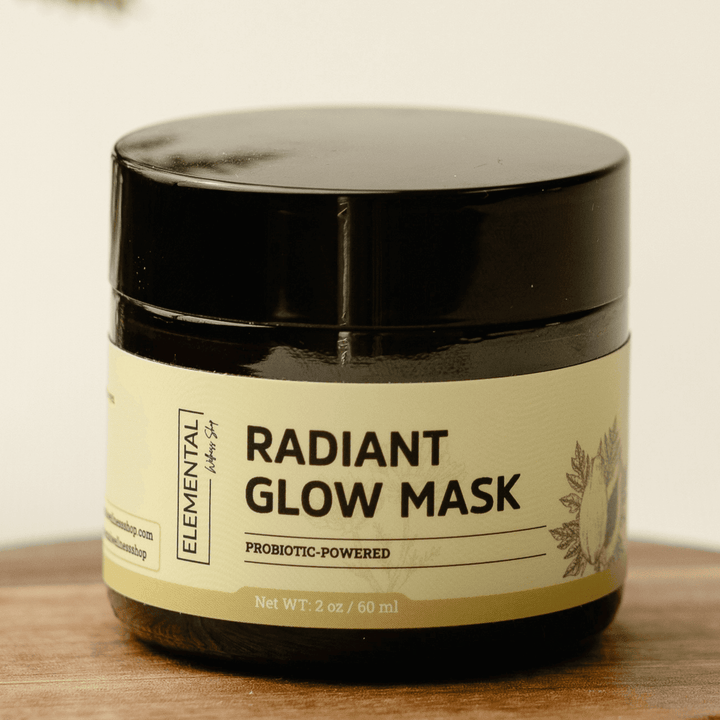 Radiant Glow Mask in a dark amber jar with a beige label, designed as a skin brightener for the face. A probiotic-powered face mask for brighter skin.
